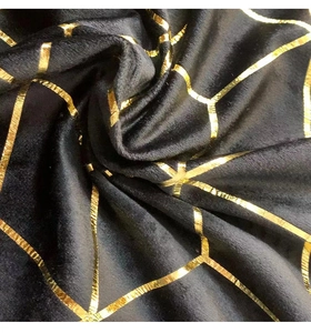 Detail of green velvet tablecloth with gold foil geometric lines and soft texture