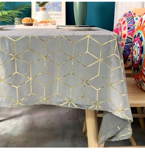 Detail of dark grey velvet tablecloth featuring luxury gold geometric hexagon patterns
