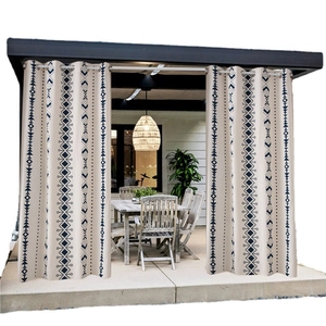Bohemian geometric printed outdoor curtain with silver metal eyelets in patio setting