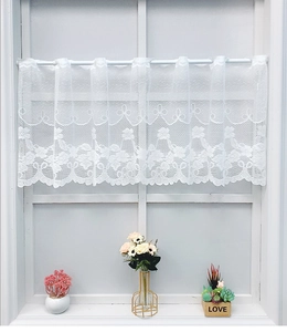 Close-up of white floral lace short curtain with elegant scalloped edges for window
