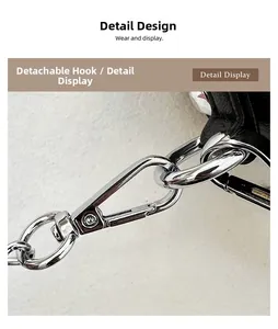 Close-up of polished silver metal detachable hook and black leather strap on handbag