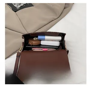 Interior view showing the large capacity of this retro brown crossbody bag