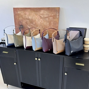 Chic underarm pillow bags in multiple colors with fabric texture and leather straps