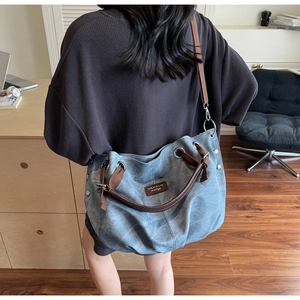 Detail of vintage canvas tote with woven handles and leather tag in a cozy room