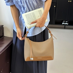 Brown woven texture shoulder bag with adjustable strap and decorative tassel