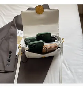 Detail of white leather handbag interior showing large capacity and zipper compartment