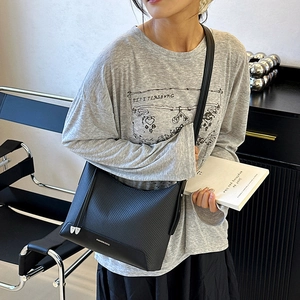 Minimalist black crossbody shoulder bag for women with woven texture and leather strap