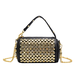 Luxurious black cylinder bag with gold studs, sparkling rhinestones and chain strap