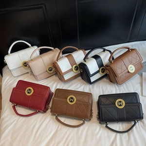Quilted luxury handbags in multiple colors with gold M buckle and top handles