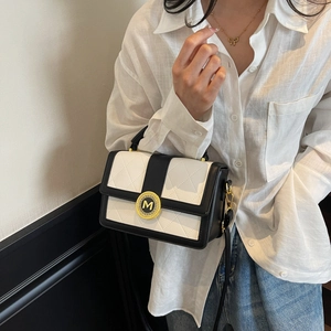 Chic black and white quilted crossbody bag with golden M-letter buckle and slim strap