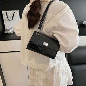 Fashionable black faux crocodile skin shoulder bag with silver chain and metal lock closure