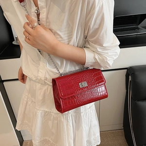 Red crocodile embossed patent leather crossbody bag with silver chain and metal lock