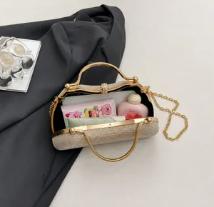 Detail view showing large interior capacity of glitter evening clutch with chain strap