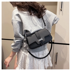 Detail showing high-quality black litchi grain leather bag with silver metal H buckle