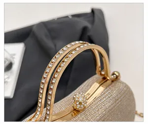 Close-up of champagne evening bag featuring rhinestone-encrusted handles and clasp detail