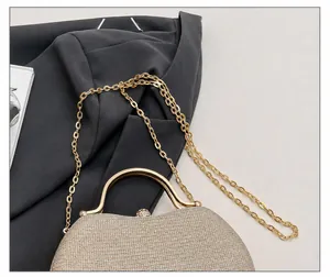 Macro detail of champagne gold glitter evening bag with crystal buckle and chain
