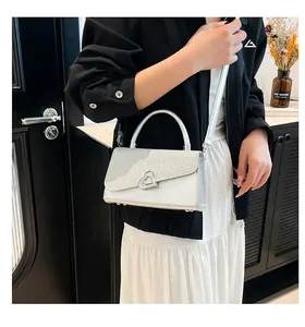 Silver sequin handbag with heart buckle shown on model for daily summer fashion style
