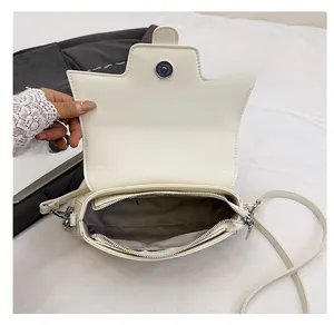 Interior view of off-white small square bag with magnetic flap and zipper pocket