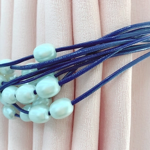 Elegant navy multi-strand curtain tieback with decorative lustrous white pearls