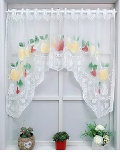 Detail of white lace cafe curtain with colorful fruit prints and wavy scallop edge