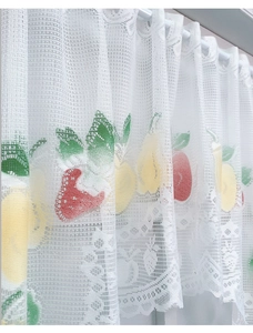 Detailed texture of white lace kitchen curtain with colorful fruit prints and rod pocket