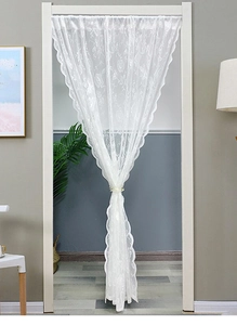 Close-up of white lace door curtain with rose floral embroidery and scalloped edges