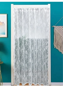 Detailed close-up of white lace door curtain with rose embroidery and wavy lace edges