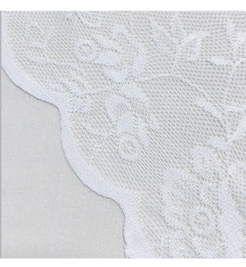 Detailed close-up of white lace door curtain with intricate floral crochet patterns