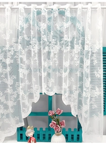 Close-up of white lace curtain featuring floral patterns and scalloped embroidery edge