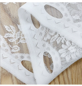 Macro shot of white floral lace curtain with exquisite mesh texture and oval eyelet edges