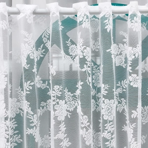 White Nordic lace cafe curtain featuring elegant floral embroidery and tab top design