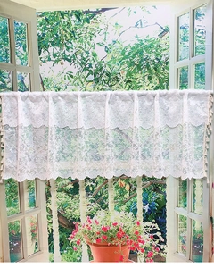 Detail of white floral lace cafe curtain with vintage embroidery and scalloped edges