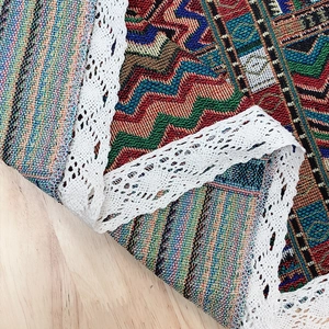 Bohemian style jacquard table runner with colorful wave patterns and white lace trim