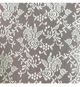 Detail of white lace fabric featuring floral patterns and delicate hollow mesh texture