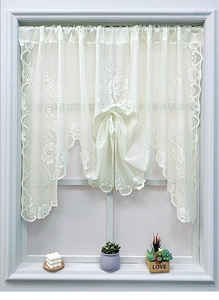 Detail of white floral lace curtain with intricate crochet patterns for windows