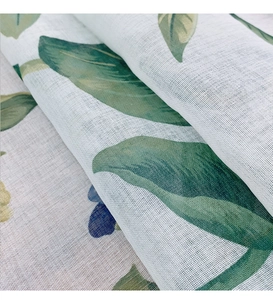 Macro detail of breathable polyester linen mesh fabric with green leaf and blue floral prints