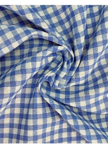 Close-up of blue and white gingham fabric showing soft cotton texture and drape
