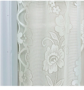 Detail of white floral lace curtain featuring delicate mesh and scalloped edges