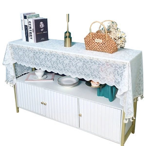 Elegant white lace table runner with floral patterns and fringe balls for cabinets