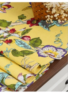 Close-up of bright yellow floral table runner with textured cotton linen fabric