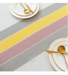 Detailed view of striped cotton linen table runner with fine stitching and fabric texture