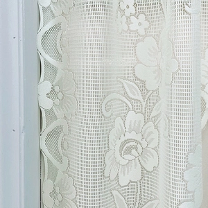 White floral lace Roman shade curtain with delicate crochet patterns and scalloped edges