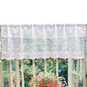White lace cafe curtain with crochet floral patterns and delicate tassel fringe