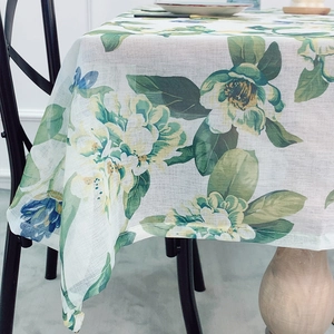 Pastel floral linen tablecloth with green leaves and yellow flowers on white background