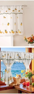 Detailed view of white cafe curtain with pineapple embroidery and scalloped green lace trim