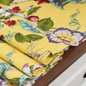 Floral table runner in bright yellow cotton linen with traditional bird and flower patterns