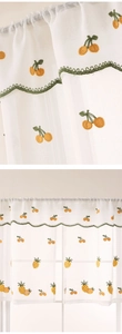 Detail of white semi-transparent cafe curtain with yellow pineapple embroidery and green wavy edge
