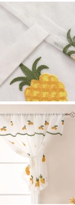 Macro detail of pineapple embroidery on semi-transparent linen textured cafe curtain