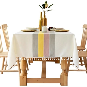 Nordic striped cotton linen tablecloth with tassels on a decorated rectangular dining table