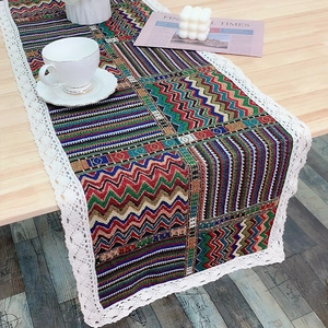 Modern Nordic woven table runner with bohemian patterns and white lace trim detail